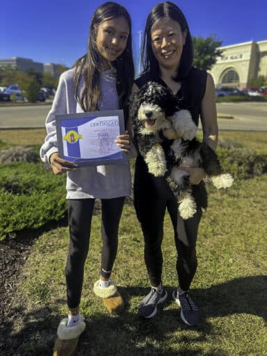 A Happy Couple picking up their Hoosier Canines Trained Bernedoodle Puppy from Training That Lasts Puppy Training Program.